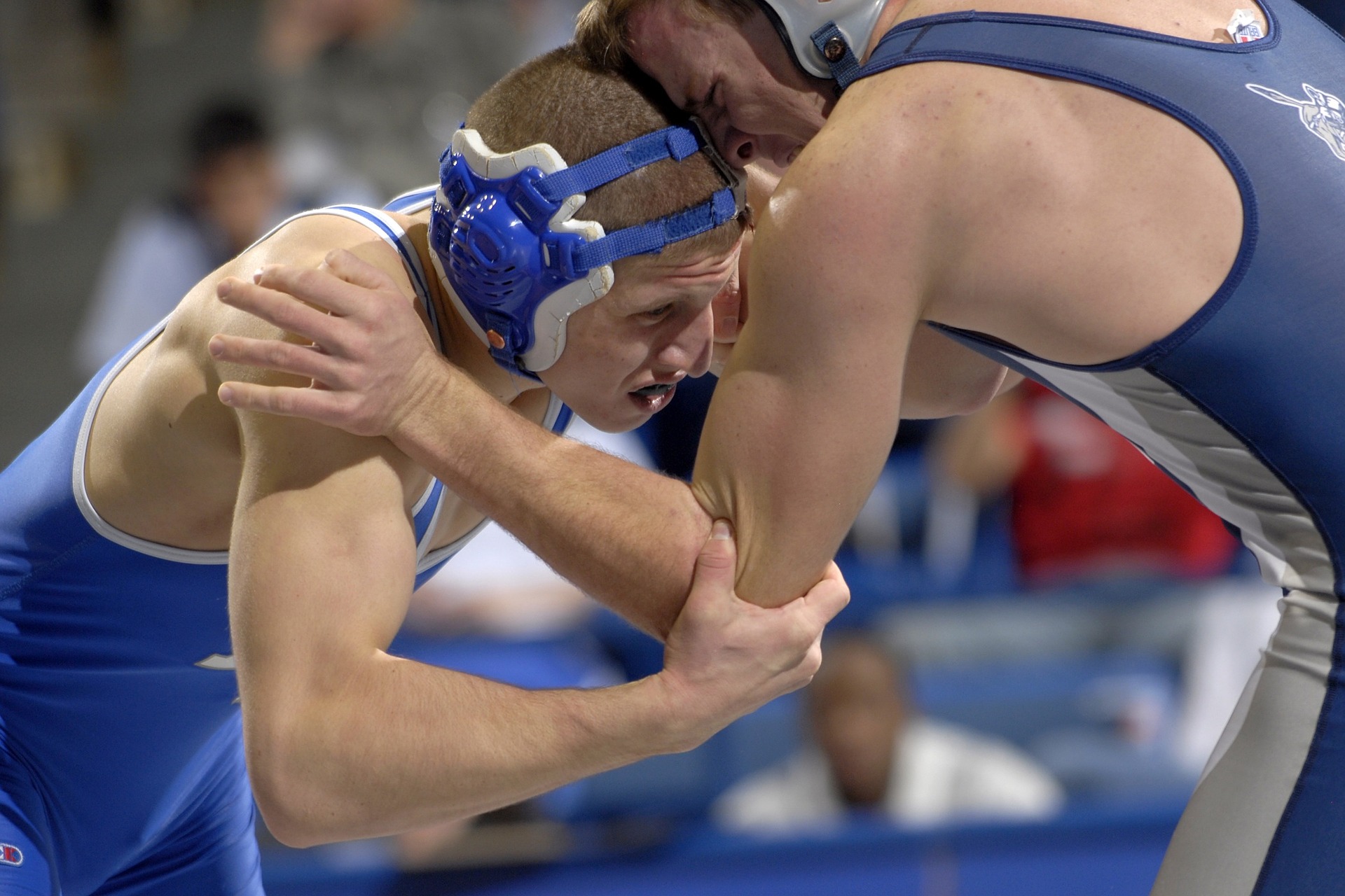 Eating disorders affect college athletes at an alarming rate. This image shows two college wrestlers, a common sport where eating disorders are prevalent.