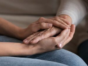 two people holding hands for care